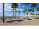 Picturesque beach scene with lounge chairs and umbrellas framed by palm trees against a clear blue sky at 3110 Up Da Creek Ct, Seabrook Island, SC 29455