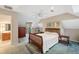 Bedroom featuring a large bed, a ceiling fan, and an adjoining bathroom and a small seating area at 3110 Up Da Creek Ct, Seabrook Island, SC 29455