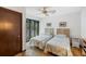 Bedroom with twin beds, neutral paint, and a large window with lush outdoor views at 3110 Up Da Creek Ct, Seabrook Island, SC 29455