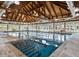 Bright indoor pool area with a wood beamed ceiling and many windows at 3110 Up Da Creek Ct, Seabrook Island, SC 29455