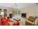 Living room with fireplace, hardwood floors, and large windows offering views of the outdoors at 3110 Up Da Creek Ct, Seabrook Island, SC 29455