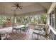 Covered porch with outdoor seating and nature views at 3110 Up Da Creek Ct, Seabrook Island, SC 29455
