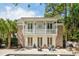 Stunning home with a brick facade, featuring a charming balcony overlooking the pool and lush landscape at 34 Frogmore Rd, Mount Pleasant, SC 29464
