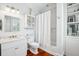 Bright and tidy bathroom with white fixtures, subway tile, and hardwood floors at 34 Frogmore Rd, Mount Pleasant, SC 29464