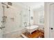 Luxurious bathroom boasts a glass-enclosed shower and classic clawfoot tub, complemented by wood floors at 34 Frogmore Rd, Mount Pleasant, SC 29464