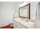 Bright bathroom with a marble countertop, decorative mirror and white walls at 34 Frogmore Rd, Mount Pleasant, SC 29464
