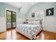 Stylish bedroom with hardwood floors, and natural light, complemented by calming walls and door to balcony at 34 Frogmore Rd, Mount Pleasant, SC 29464