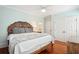 Charming bedroom with hardwood floors, decorative headboard, and light blue walls at 34 Frogmore Rd, Mount Pleasant, SC 29464