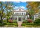 Charming two-story home features a classic front porch and manicured landscaping creating an inviting curb appeal at 34 Frogmore Rd, Mount Pleasant, SC 29464