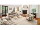 Well-lit living room with a brick fireplace, comfortable couches, and an elegant, clear coffee table at 34 Frogmore Rd, Mount Pleasant, SC 29464
