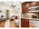 Cozy living area boasts stylish kitchenette with wood cabinets, hardwood floors, and ample natural light at 34 Frogmore Rd, Mount Pleasant, SC 29464