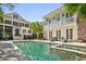 Beautiful backyard pool area with two story home, patio, and lush greenery for a relaxing outdoor experience at 34 Frogmore Rd, Mount Pleasant, SC 29464