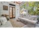 Inviting screened porch featuring ample seating and a view of the home's exterior at 34 Frogmore Rd, Mount Pleasant, SC 29464