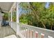 Relaxing covered porch with seating and view of lush greenery and tropical landscaping at 34 Frogmore Rd, Mount Pleasant, SC 29464