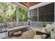Cozy screened porch with comfortable seating and a view of the lush outdoors at 34 Frogmore Rd, Mount Pleasant, SC 29464