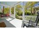 Inviting porch with swing, rocking chairs, and a picturesque outdoor view at 34 Frogmore Rd, Mount Pleasant, SC 29464