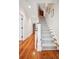 Hallway featuring hardwood floors leading to a carpeted staircase at 34 Frogmore Rd, Mount Pleasant, SC 29464