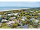 Expansive aerial view of charming beach houses nestled among lush greenery, with the serene ocean stretching to the horizon at 3405 Cameron Blvd, Isle of Palms, SC 29451