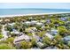 Aerial view of a coastal neighborhood with mature trees and homes, located near sandy beach and ocean at 3405 Cameron Blvd, Isle of Palms, SC 29451