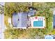 An aerial view of a home with a backyard pool, patio area, and mature trees surrounding the property at 3405 Cameron Blvd, Isle of Palms, SC 29451