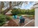 Relaxing backyard featuring a fire pit with chairs, lush landscaping, and a peek at the inviting pool at 3405 Cameron Blvd, Isle of Palms, SC 29451