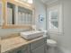 Stylish bathroom with a granite countertop, updated fixtures and natural light at 3405 Cameron Blvd, Isle of Palms, SC 29451