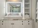 Modern bathroom with a large sink, vanity, illuminated mirror, and open shelving for towels at 3405 Cameron Blvd, Isle of Palms, SC 29451