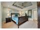 Comfortable bedroom featuring a tray ceiling, fan, and natural light at 3405 Cameron Blvd, Isle of Palms, SC 29451