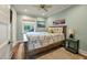 Light-filled bedroom with a wooden-frame bed, neutral decor, and view of the porch at 3405 Cameron Blvd, Isle of Palms, SC 29451