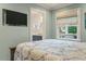 Bedroom featuring light blue walls, a TV, and a peek at an en-suite bathroom at 3405 Cameron Blvd, Isle of Palms, SC 29451