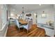 Bright dining room with a large table, comfortable seating, and views of the modern kitchen at 3405 Cameron Blvd, Isle of Palms, SC 29451