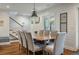 Open-concept dining area with shiplap walls, modern lighting, and staircase access at 3405 Cameron Blvd, Isle of Palms, SC 29451