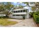 Charming two-story home with a screened porch, white picket fence, and a well-maintained yard at 3405 Cameron Blvd, Isle of Palms, SC 29451