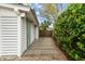 Exterior view of a home with a gated walkway, lush greenery, and clean, horizontal siding at 3405 Cameron Blvd, Isle of Palms, SC 29451