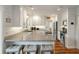 Well-lit kitchen with granite countertops, stainless steel appliances, and modern stools at 3405 Cameron Blvd, Isle of Palms, SC 29451