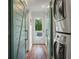 Efficient laundry room featuring a stacked washer and dryer and rustic sliding barn doors at 3405 Cameron Blvd, Isle of Palms, SC 29451
