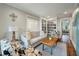 Cozy living room has a built-in bookcase, stylish seating, and a view into a bedroom at 3405 Cameron Blvd, Isle of Palms, SC 29451