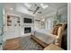 Sunlit main bedroom features a fireplace, built-in shelves, ceiling fan, and stylish decor at 3405 Cameron Blvd, Isle of Palms, SC 29451