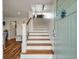 Stylish entryway featuring hardwood stairs, shiplap walls, and a charming blue door at 3405 Cameron Blvd, Isle of Palms, SC 29451