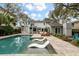 Backyard swimming pool and lounge area with built in tanning deck and landscaped surroundings at 3405 Cameron Blvd, Isle of Palms, SC 29451
