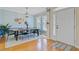 Bright dining area with hardwood floors, large windows, modern lighting and a stylish wooden table at 3447 Toomer Kiln Cir, Mount Pleasant, SC 29466
