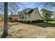 A well-maintained house with a wooden deck, and well placed shrubbery in the backyard at 3447 Toomer Kiln Cir, Mount Pleasant, SC 29466
