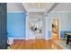 Entryway showcasing wood floors, staircase and an open floor plan leading to kitchen and living areas at 3447 Toomer Kiln Cir, Mount Pleasant, SC 29466