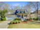 Charming yellow home featuring a quaint front porch with decorative flower boxes and lush landscaping at 3447 Toomer Kiln Cir, Mount Pleasant, SC 29466