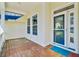 View of the front porch with wooden flooring, white railings, and a clear view through the glass front door at 3447 Toomer Kiln Cir, Mount Pleasant, SC 29466