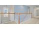 Upstairs hallway featuring a railing, bright sunlight, and neutral paint at 3447 Toomer Kiln Cir, Mount Pleasant, SC 29466