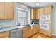 Well-lit kitchen with stainless steel dishwasher, microwave, and wooden cabinets at 3447 Toomer Kiln Cir, Mount Pleasant, SC 29466