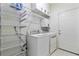 Well-equipped laundry room with washer, dryer, storage shelves, and a utility sink at 3447 Toomer Kiln Cir, Mount Pleasant, SC 29466