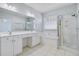 Elegant main bathroom with double vanity, a soaking tub, and a glass-enclosed shower at 3447 Toomer Kiln Cir, Mount Pleasant, SC 29466
