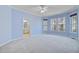 Spacious main bedroom with ensuite bathroom, large windows offering natural light, and a ceiling fan at 3447 Toomer Kiln Cir, Mount Pleasant, SC 29466